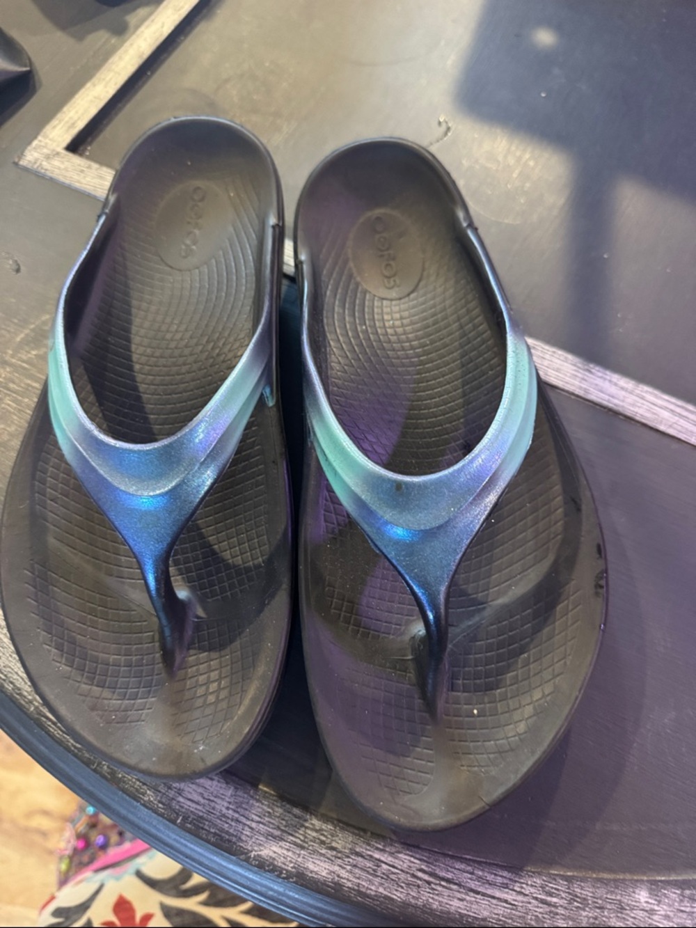 OOFOS Black Flip Flops with Iridescent Teal-Blue Straps